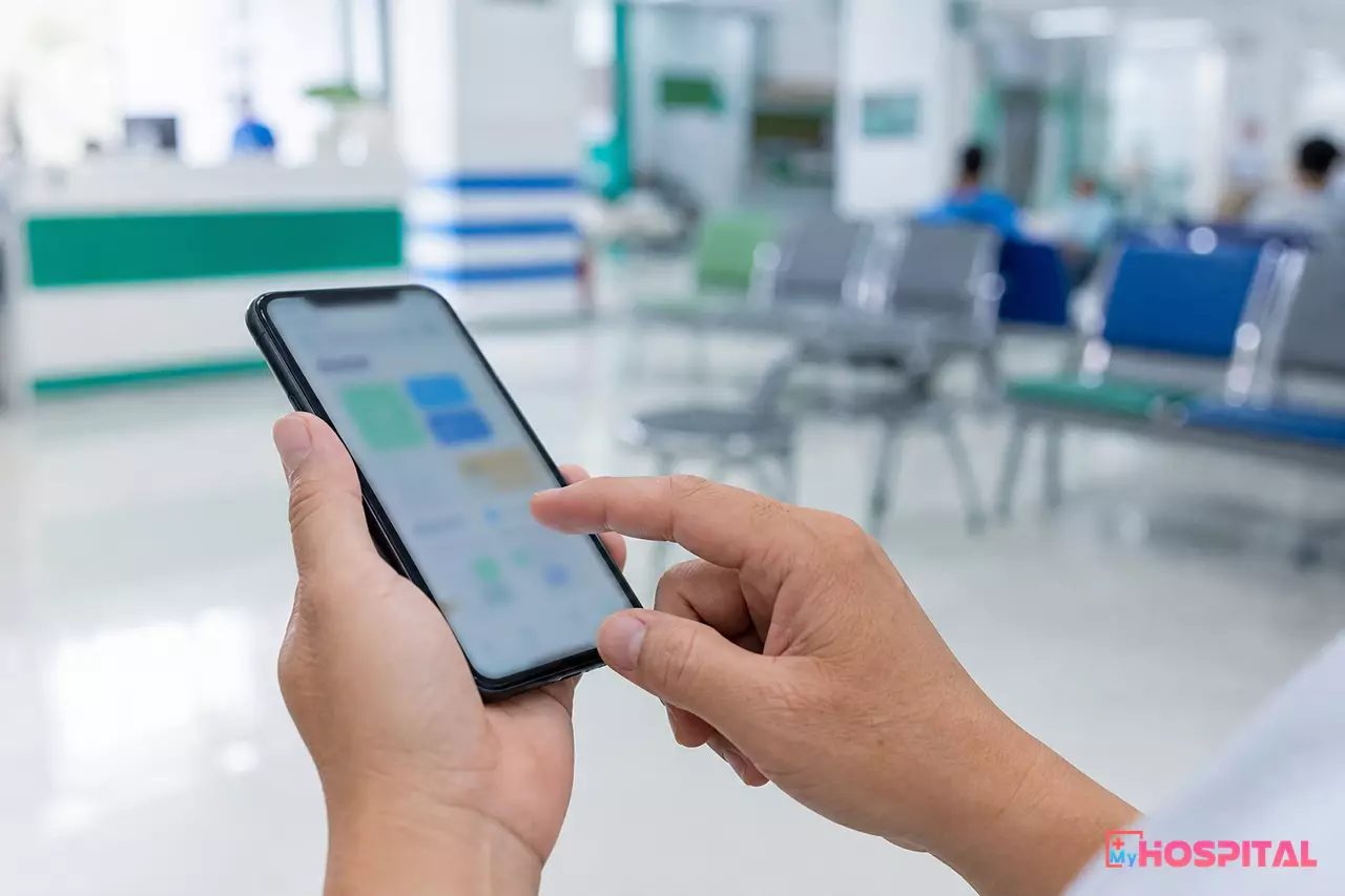 Người bệnh chạm tay vào màn hình điện thoại thông minh tại khu vực chờ của bệnh viện