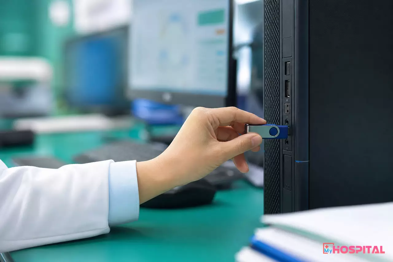 Cận cảnh token chữ ký số USB cắm vào cổng máy tính tại quầy thu ngân bệnh viện